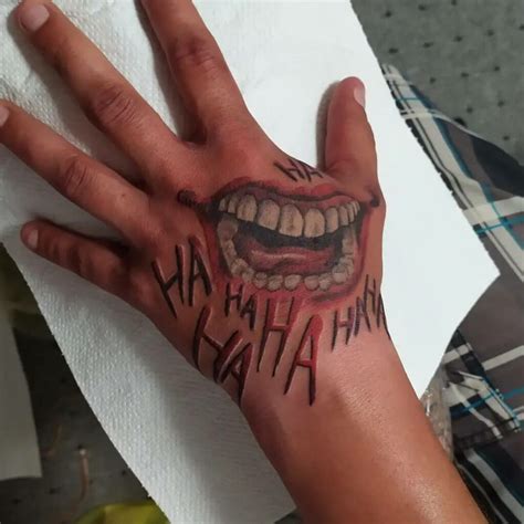 joker smile tattoo on hand